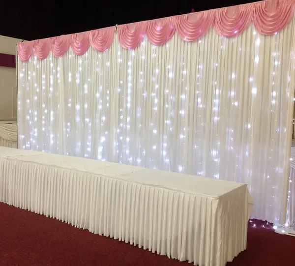 Ivory backdrop with lights and table skirting