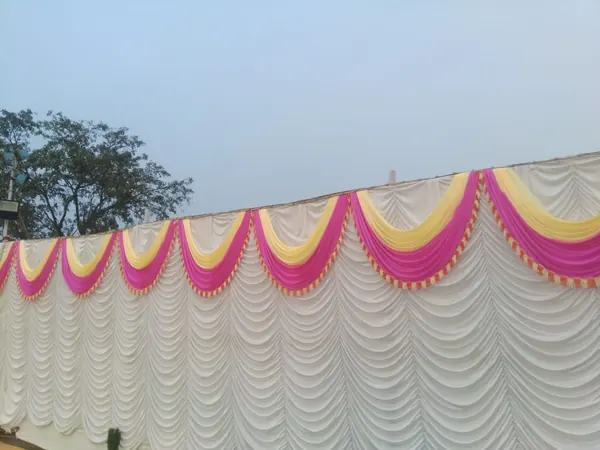Pink and yellow swag on white drape
